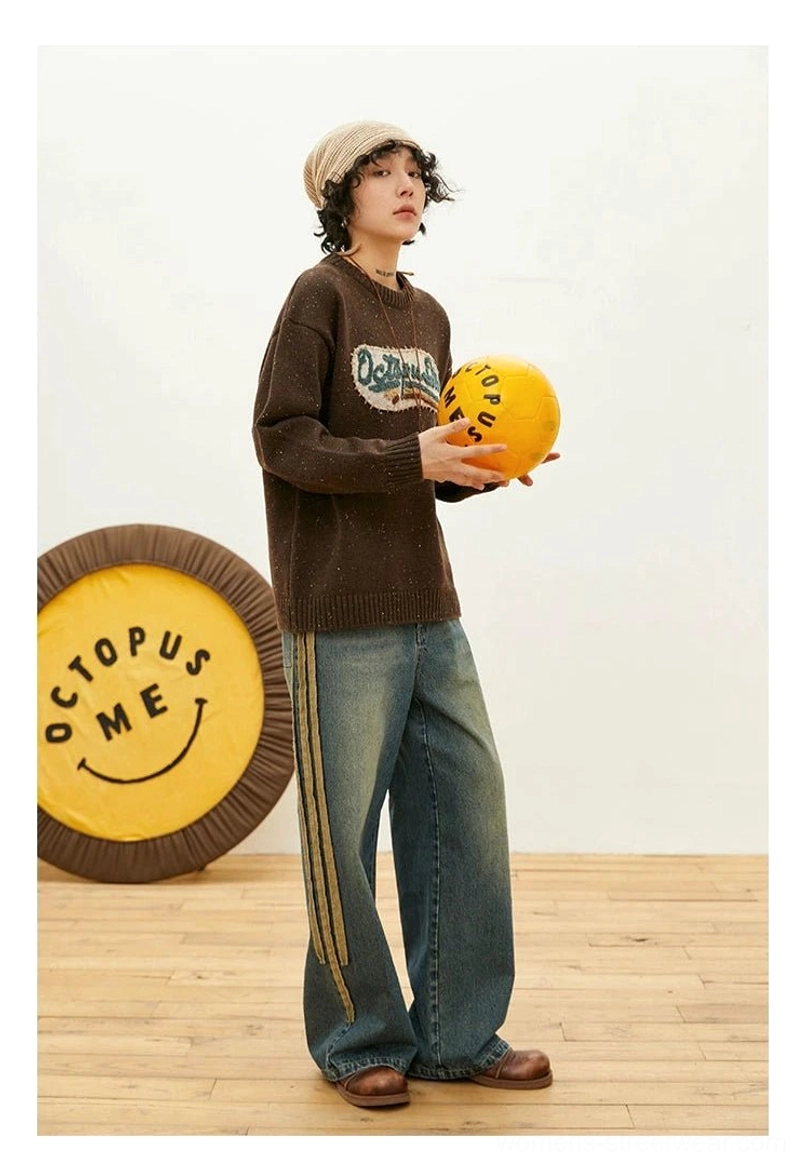 Relaxed vintage-inspired crewneck knit sweater with textured embroidered chest patch, ribbed trims, and contemporary streetwear silhouette
