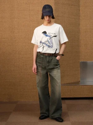 Full-body model wearing a relaxed white jazz sketch graphic tee with wide-leg denim and a denim cap