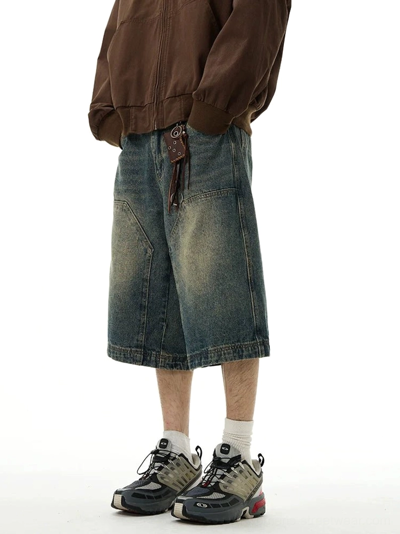 Three-quarter front view of relaxed wide-leg blue denim shorts with distressed vintage wash, oversized utility pockets, and casual Korean streetwear styling
