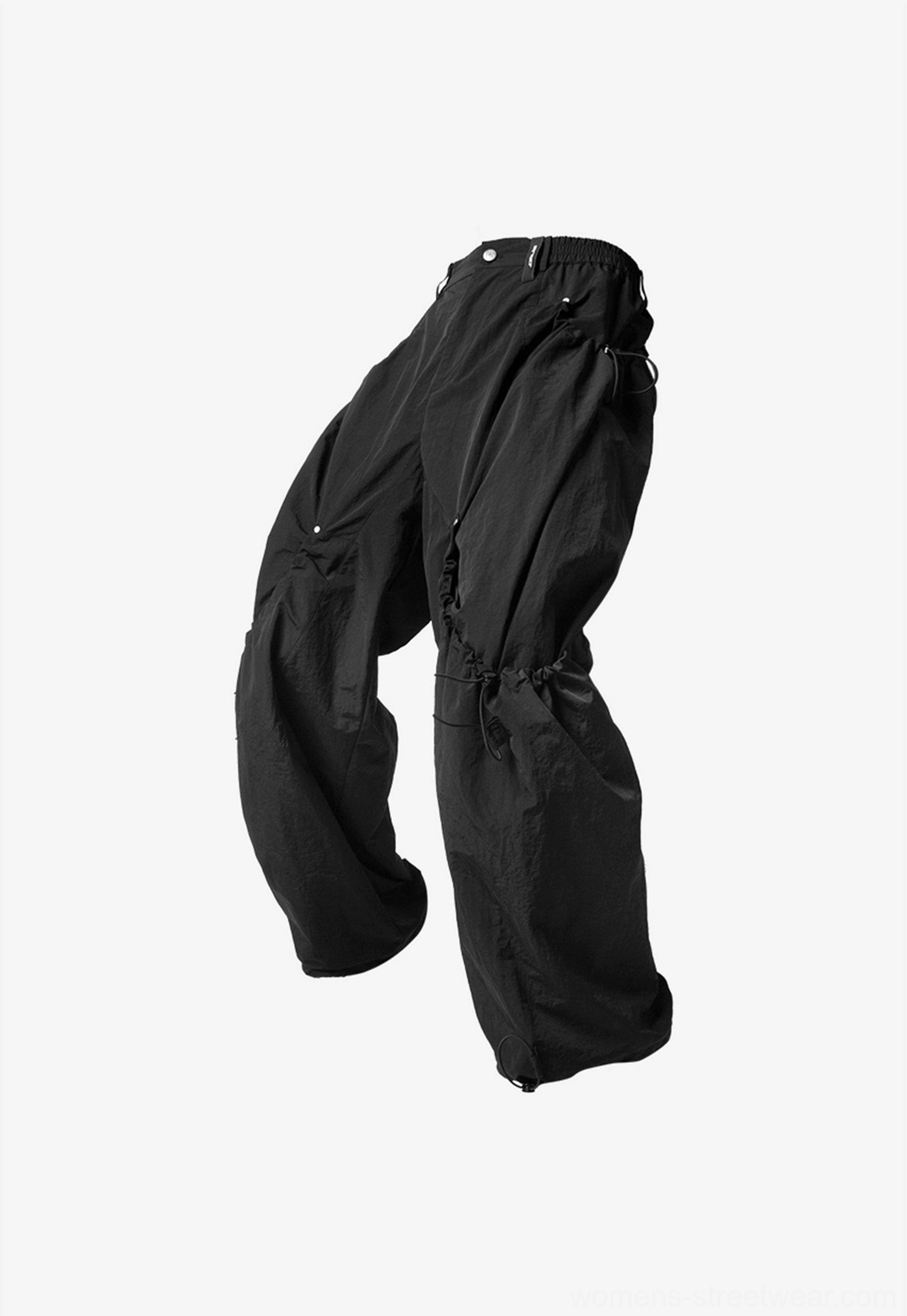 Relaxed wide leg cargo pants with drawstring waist available in versatile black and dark brown streetwear colors