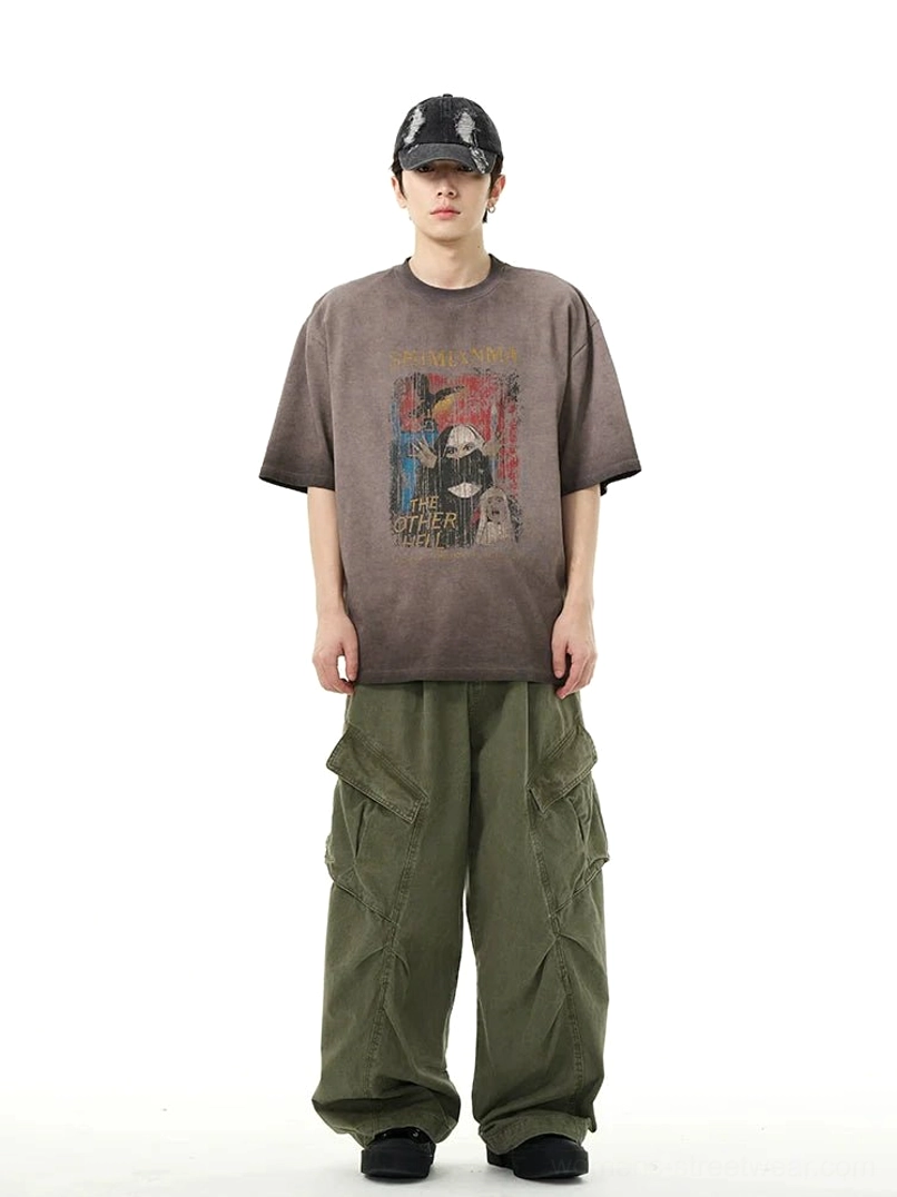 Relaxed wide-leg streetwear cargo pants styled with a vintage graphic tee and baseball cap, showcasing the practical workwear silhouette and oversized utility pockets