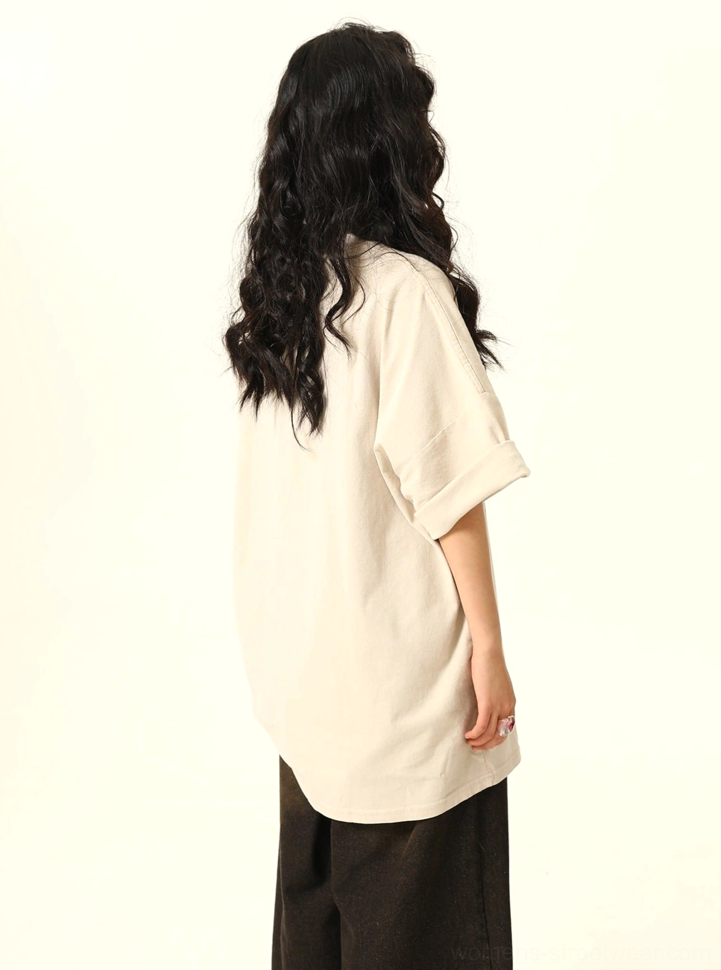 Back view of apricot beige oversized retro game T-shirt for women with plain back and rolled short sleeves