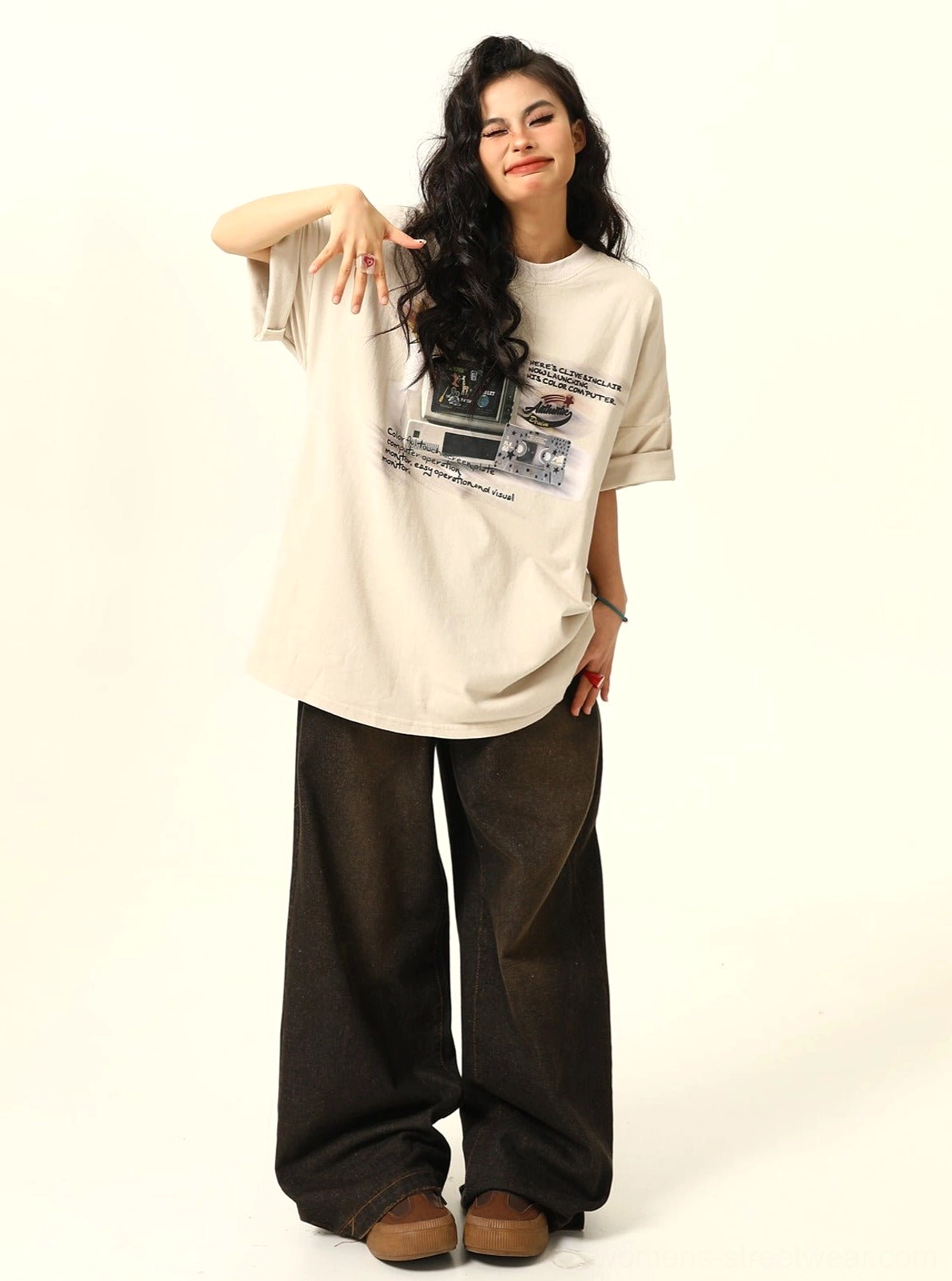 Apricot retro arcade print oversized women’s streetwear T-shirt paired with dark wide-leg trousers