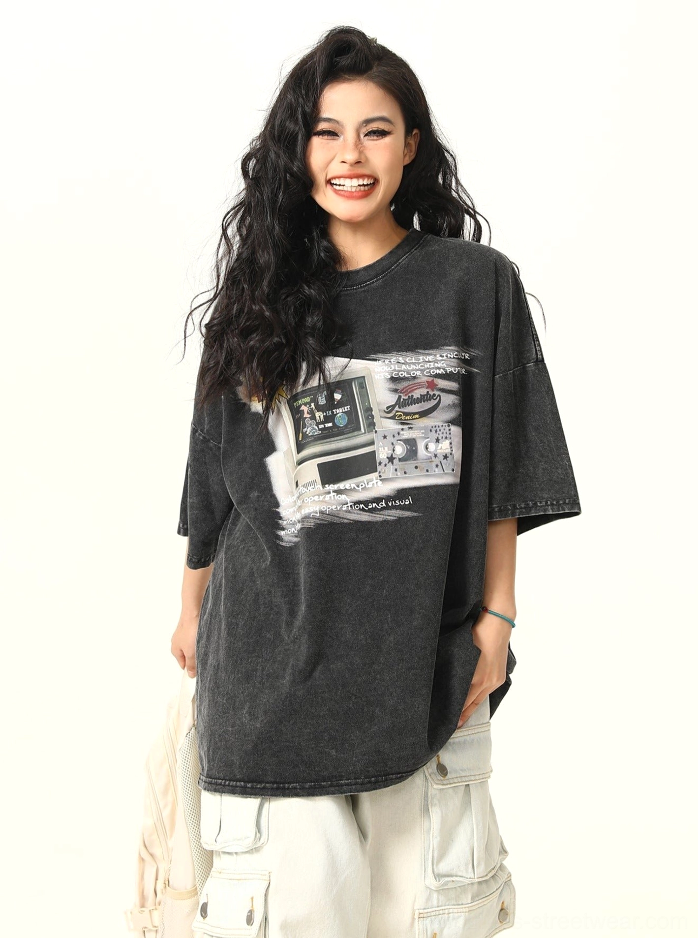 Washed black retro arcade graphic oversized T-shirt for women styled with white cargo pants front view