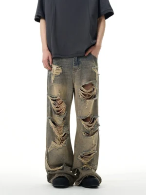 Front low angle view of retro blue distressed wide-leg ripped jeans styled with an oversized dark streetwear t-shirt