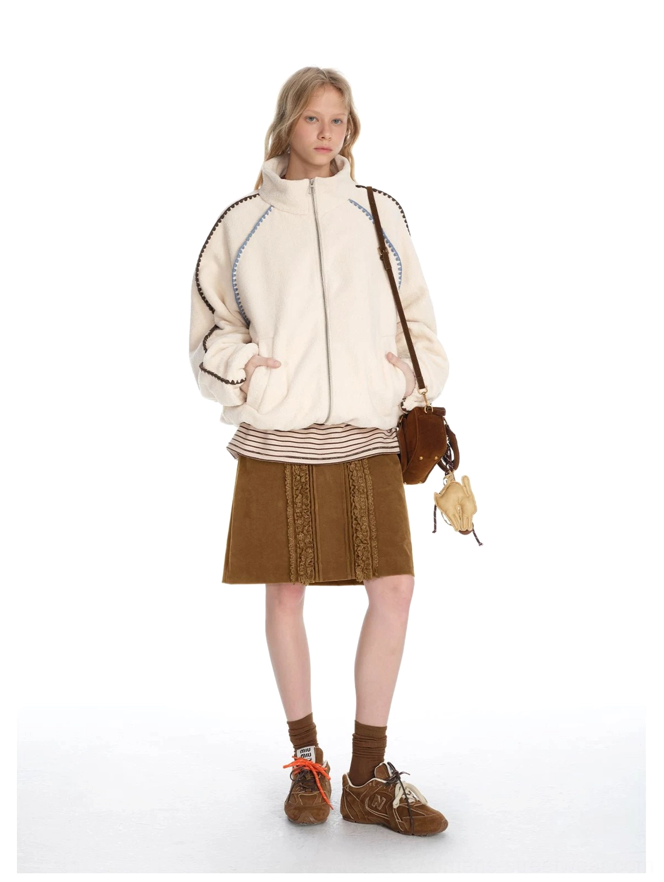 Retro brown corduroy lace panel skirt styled with a fleece jacket and striped top in a layered autumn streetwear look