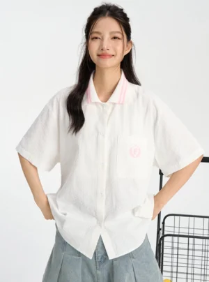 White pink retro collegiate oversized button-up shirt with striped collar and embroidered chest badge front view