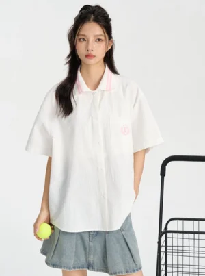 White pink preppy streetwear college shirt styled with denim pleated skirt and sporty striped collar