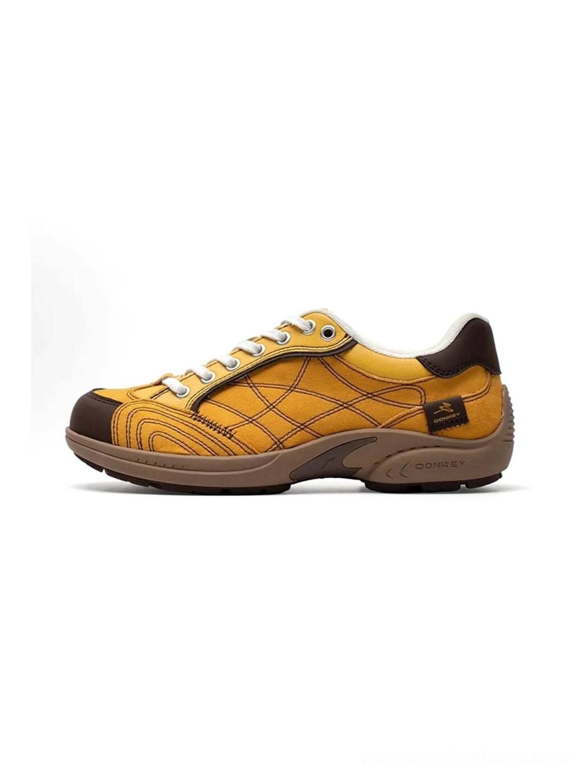 Left side profile view of retro colorblock German trainer sneaker with yellow upper and brown toe cap, showing stitched grid texture and vintage runner sole design