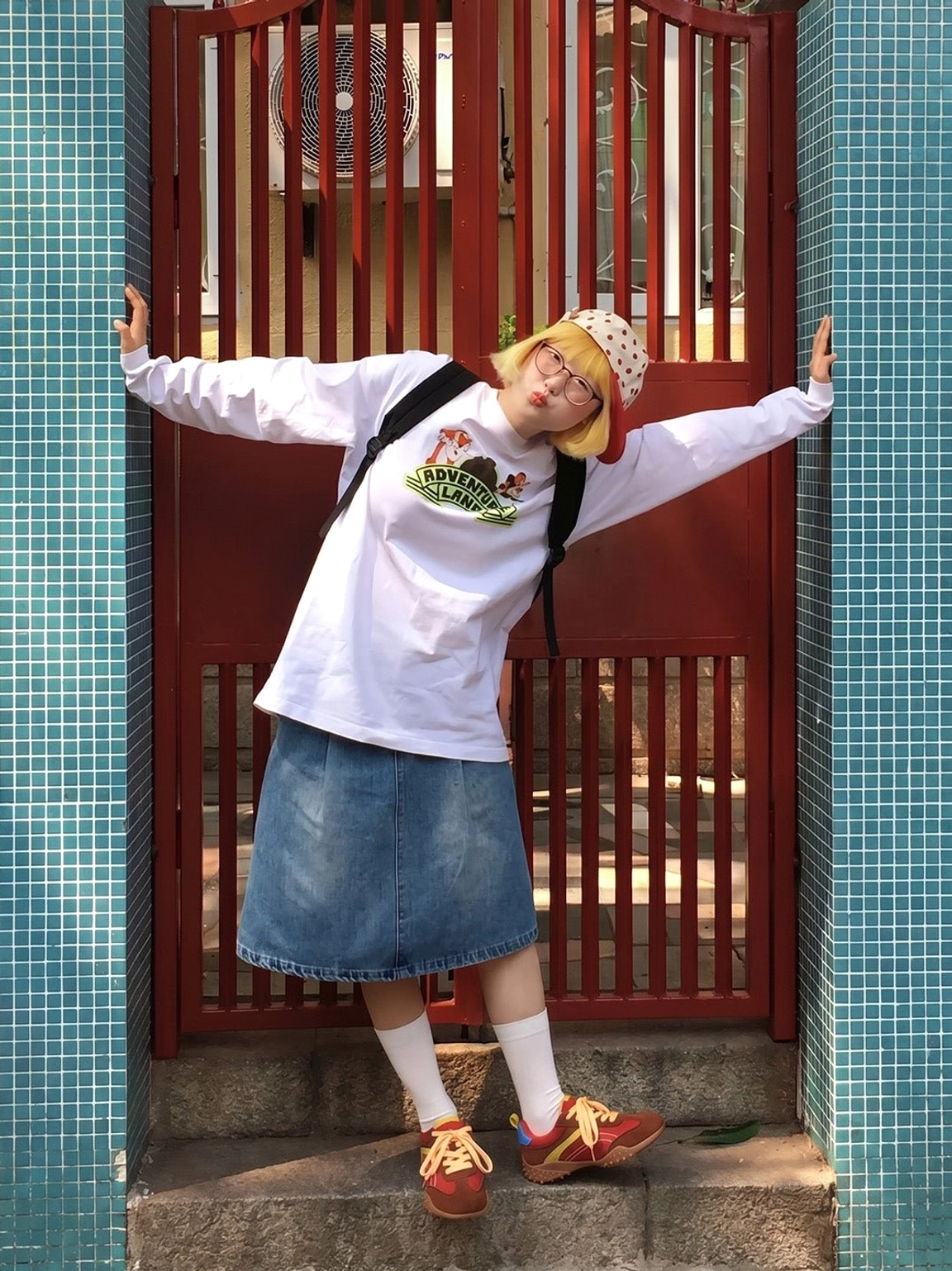 Full-body street style outfit featuring women's retro colorblock trainers with a backpack, denim skirt and casual East Asian fashion influence