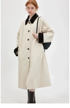 Women’s retro contrast trim corduroy long trench coat in beige and black worn by model front view