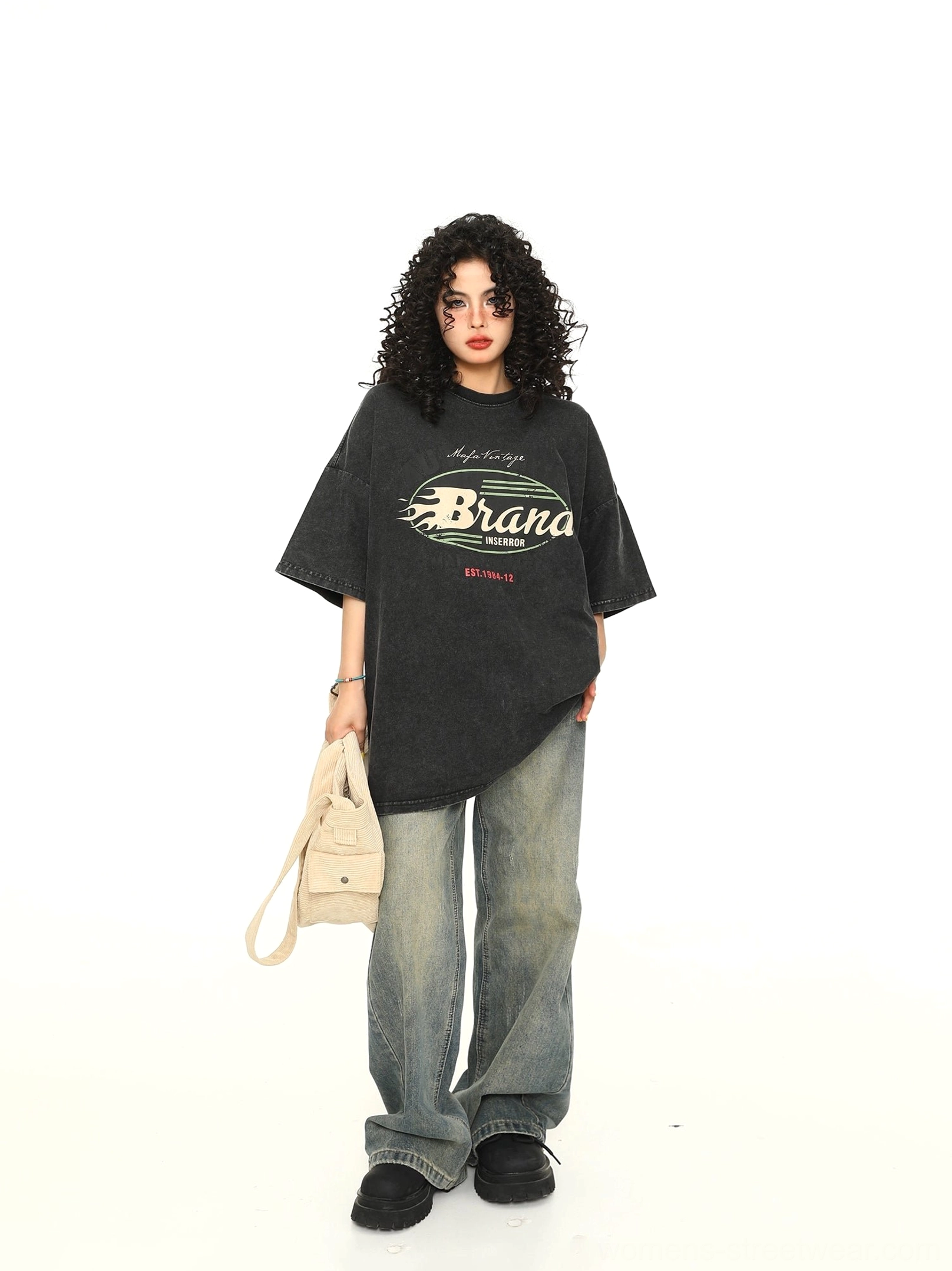 Black vintage wash oversized graphic T-shirt styled with baggy jeans and canvas tote bag