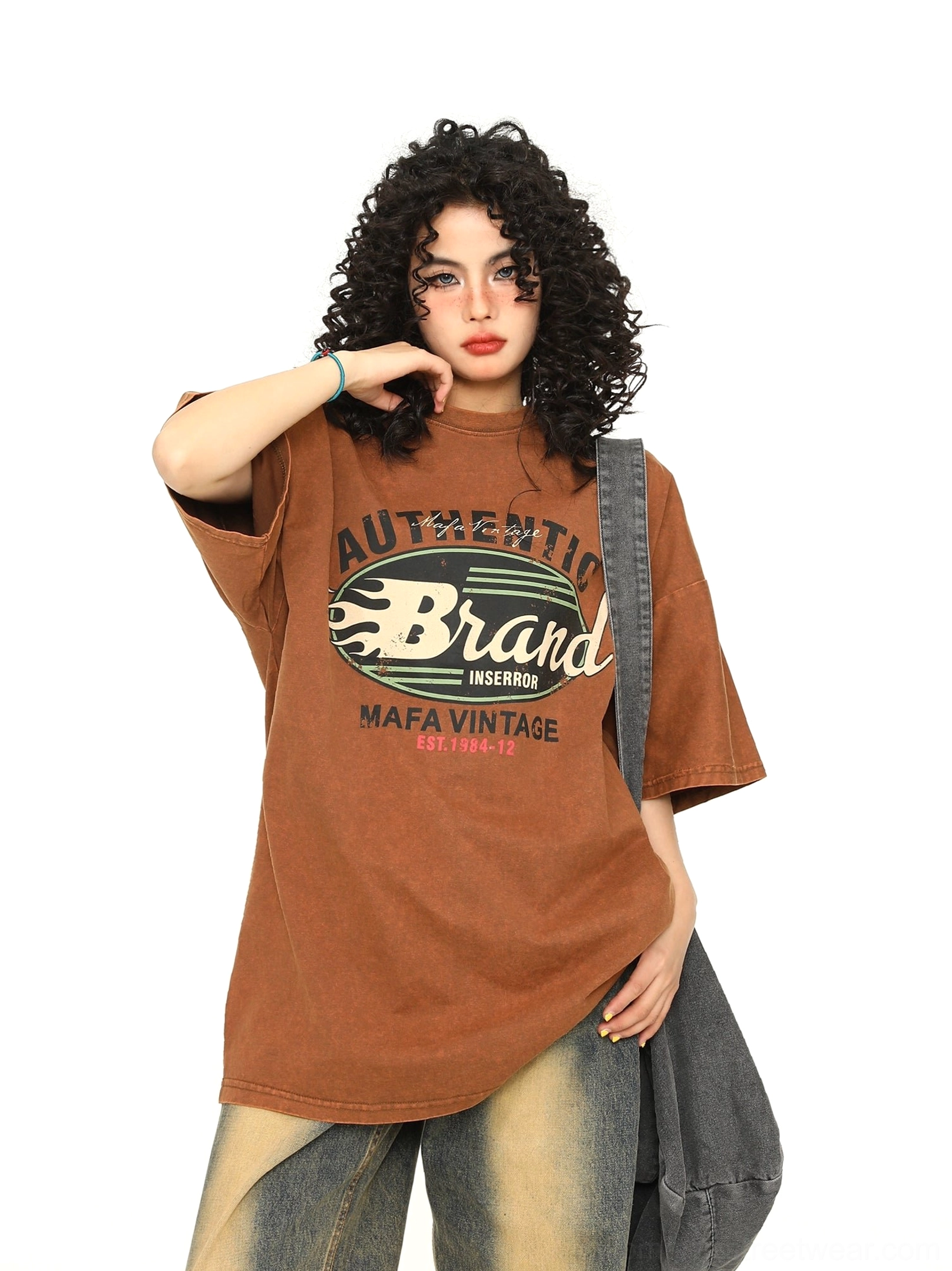 Brown vintage washed retro flame graphic oversized T-shirt with relaxed wide-leg jeans styling