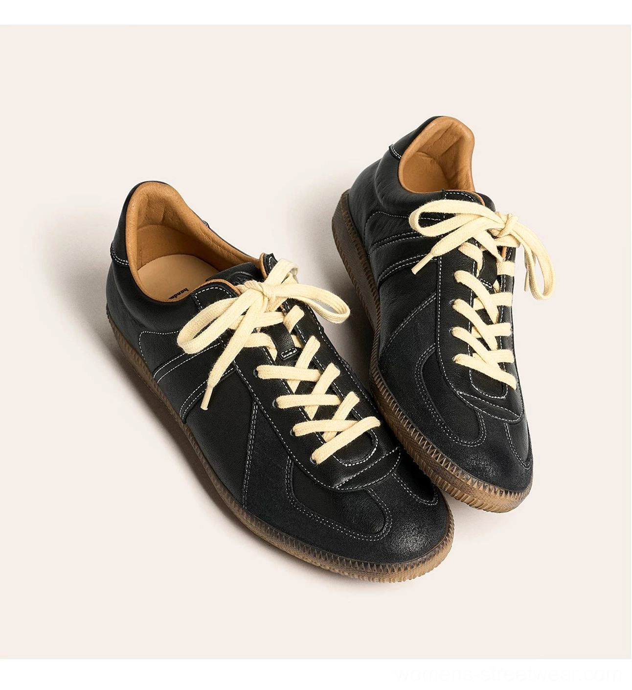 Black vintage gum sole leather sneakers in angled flat lay showing low-profile streetwear silhouette and leather insoles