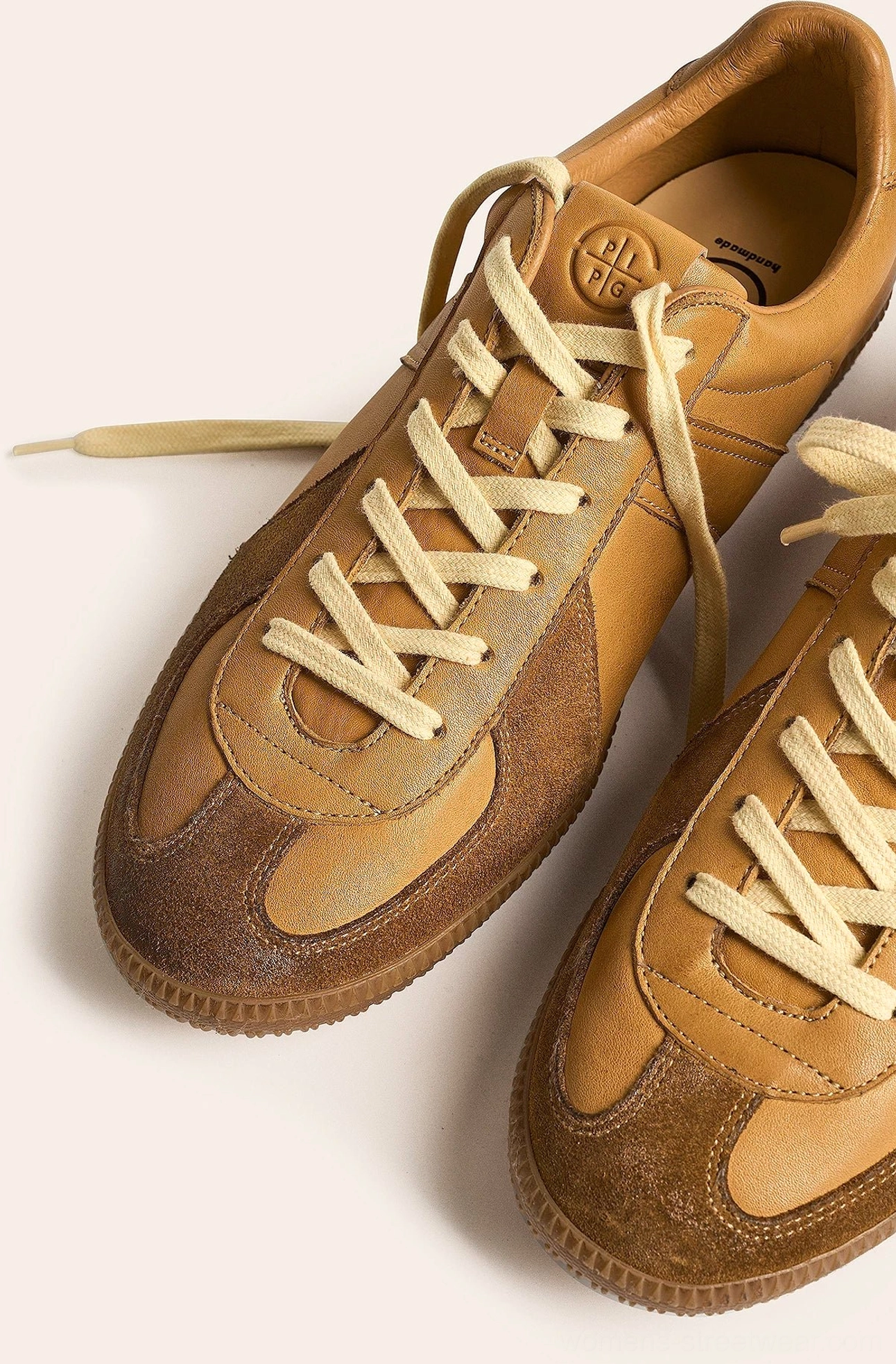 Vintage gum sole retro leather sneakers showing low-top streetwear construction and suede accent details