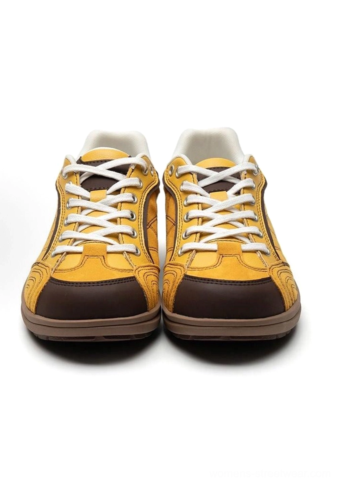 Front top-down product display of paired retro German trainer sneakers showing brown toe caps white laces and uniform grid texture on uppers