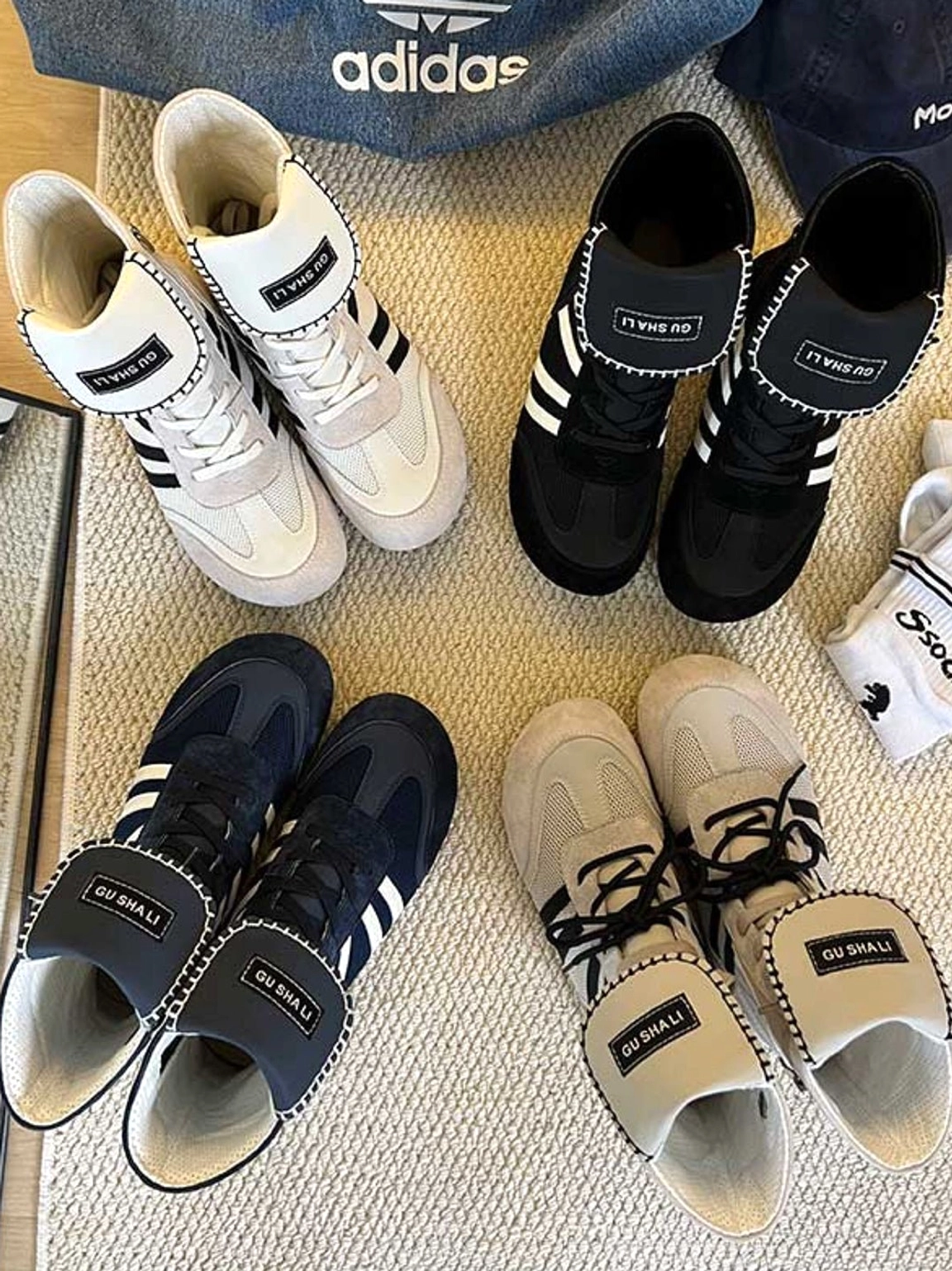 Overhead flat lay of retro boxing-inspired footwear collection displaying multiple high-top trainer boot color options