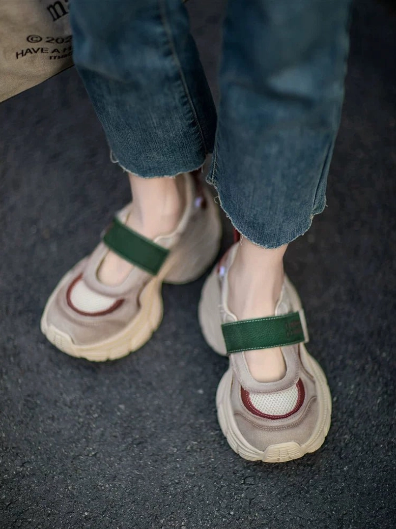 Close side view of retro Mary Jane platform sneakers with green strap, maroon toe detail, breathable mesh panel, layered khaki upper, and raised platform outsole