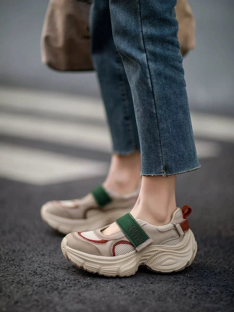 Back-side view of retro Mary Jane platform sneakers with green adjustable strap, maroon toe accent, heel pull tab, and chunky rubber outsole worn with straight-leg jeans