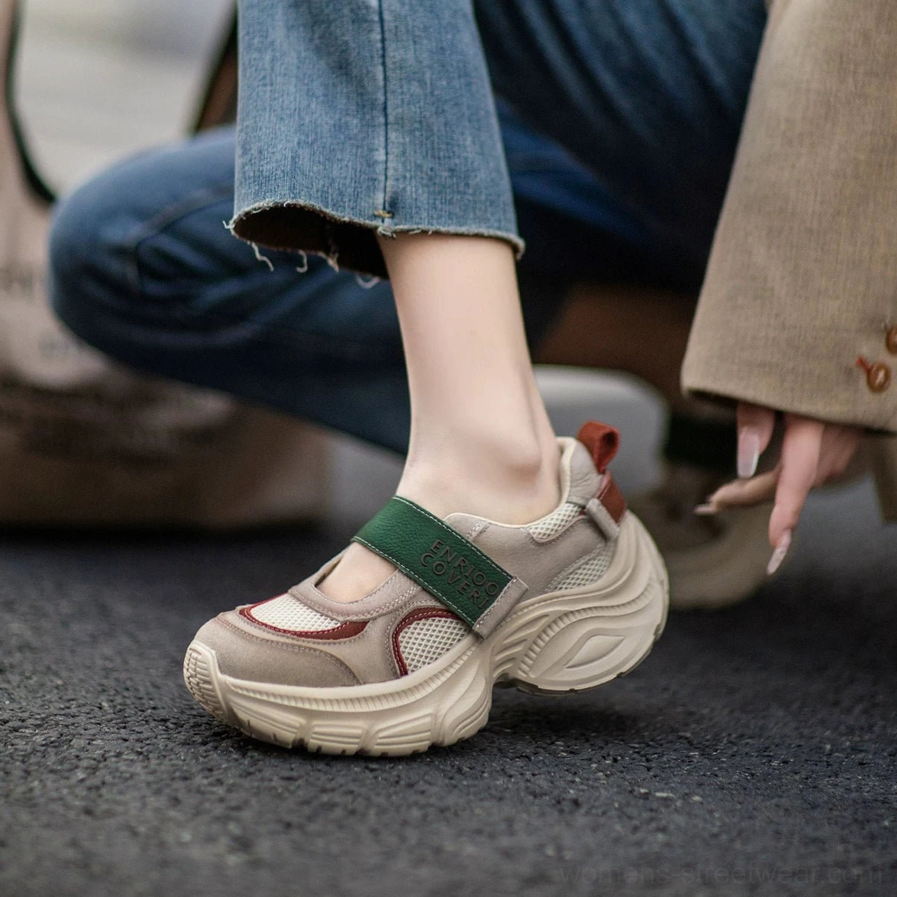 Low-angle streetwear view of retro Mary Jane platform sneaker with green hook and loop strap, maroon toe cap, heel pull tab, and elevated rubber platform sole