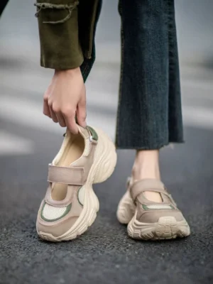 Retro Mary Jane platform sneakers shown worn and held outdoors with cropped flared jeans, breathable mesh toe panel, khaki upper, and off-white sculpted platform sole