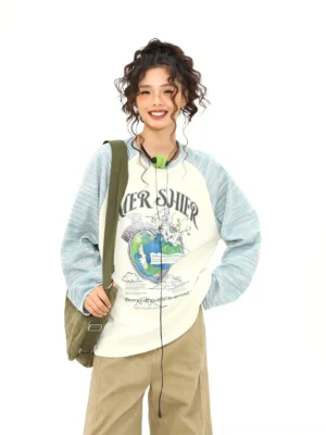 Oversized apricot and pale blue raglan graphic long sleeve tee with retro earth print and crossbody bag outfit