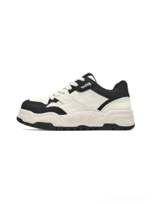 Black and white retro platform skate sneakers shown in left side profile with a chunky lifted outsole and contrasting color block design