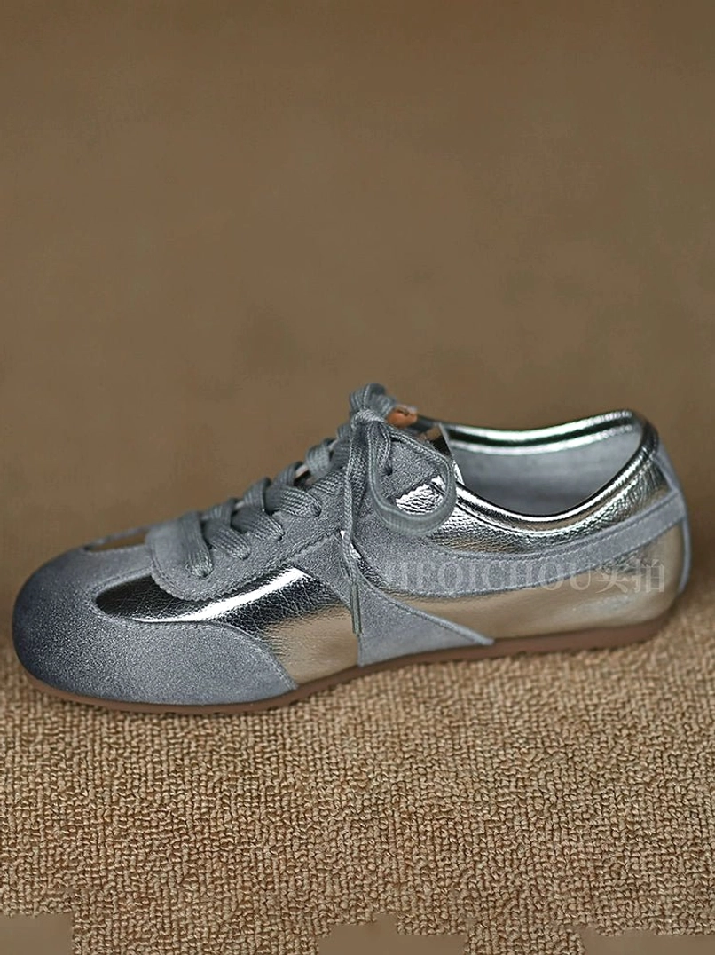Retro Silver two-tone leather sneakers with metallic silver and matte gray panels, stripe detailing, and classic low-top lace-up construction