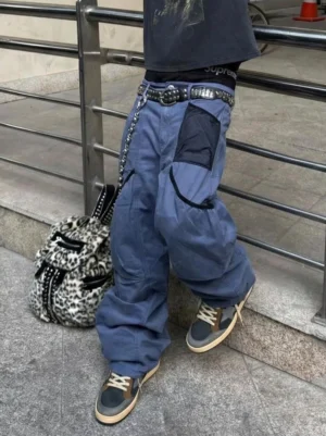 Retro star panel sneakers styled with baggy blue cargo pants in an urban streetwear setting near metal railings and a leopard print backpack