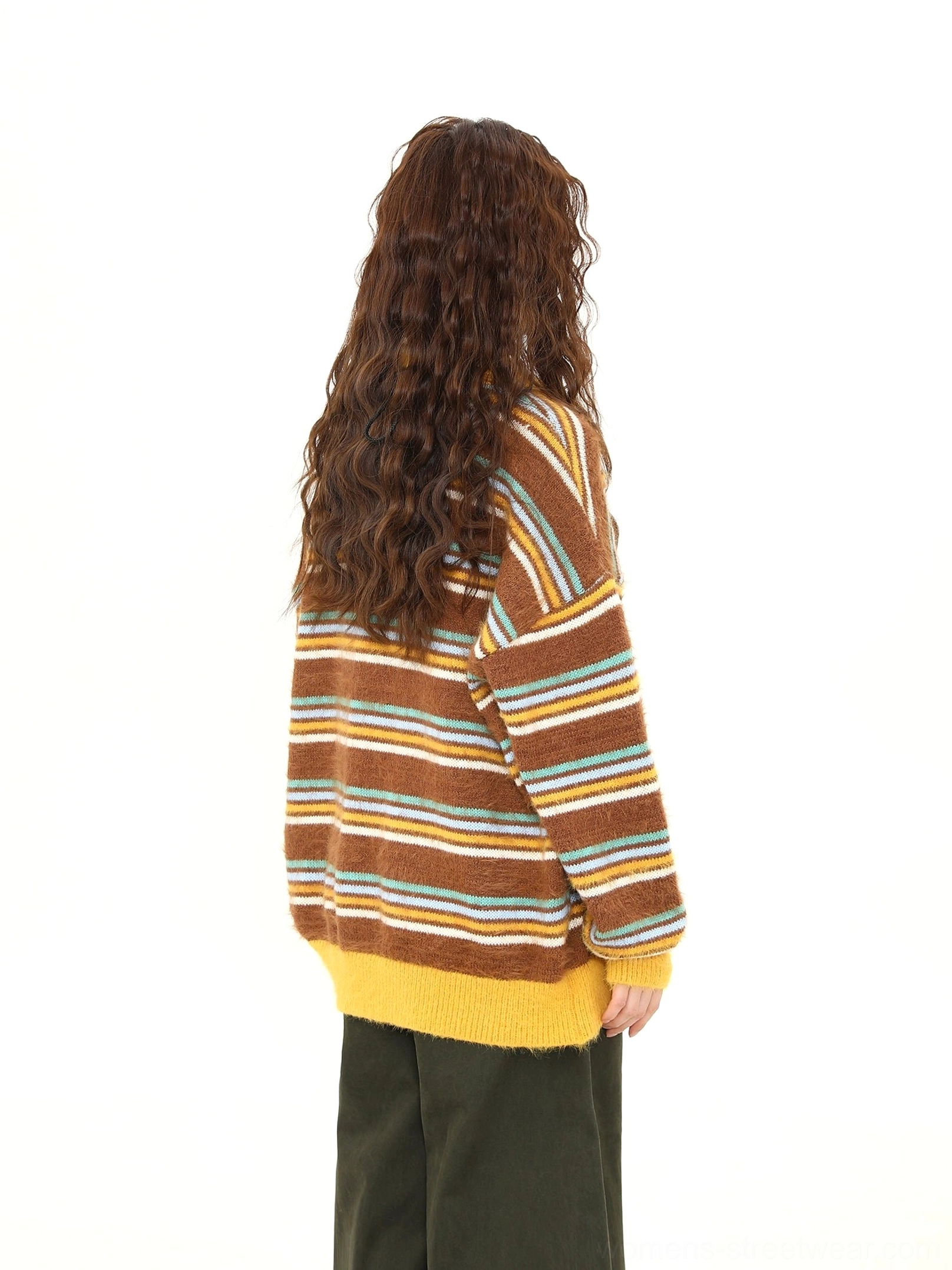 Back view of a loose retro striped fuzzy knit sweater showing full sleeve stripes, yellow ribbed cuffs, ribbed hem, and relaxed streetwear silhouette