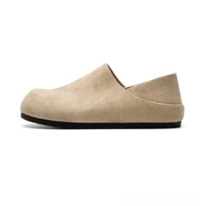 Light beige retro suede clogs with rounded closed toe fold-down heel and black rubber outsole shown in a clean side view