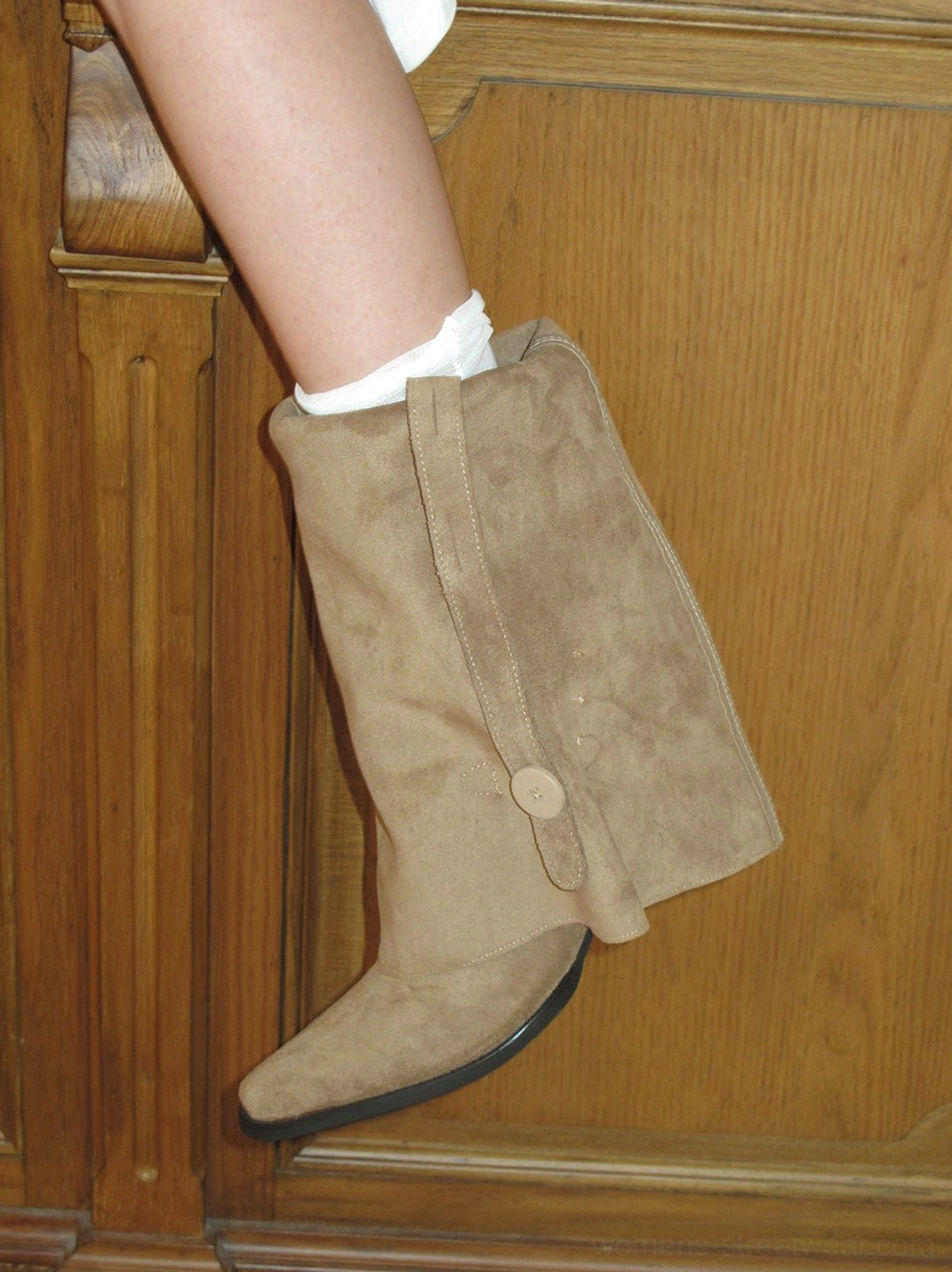 Side close-up of khaki retro slouch riding boot with textured suede-look upper pointed toe and ankle detail