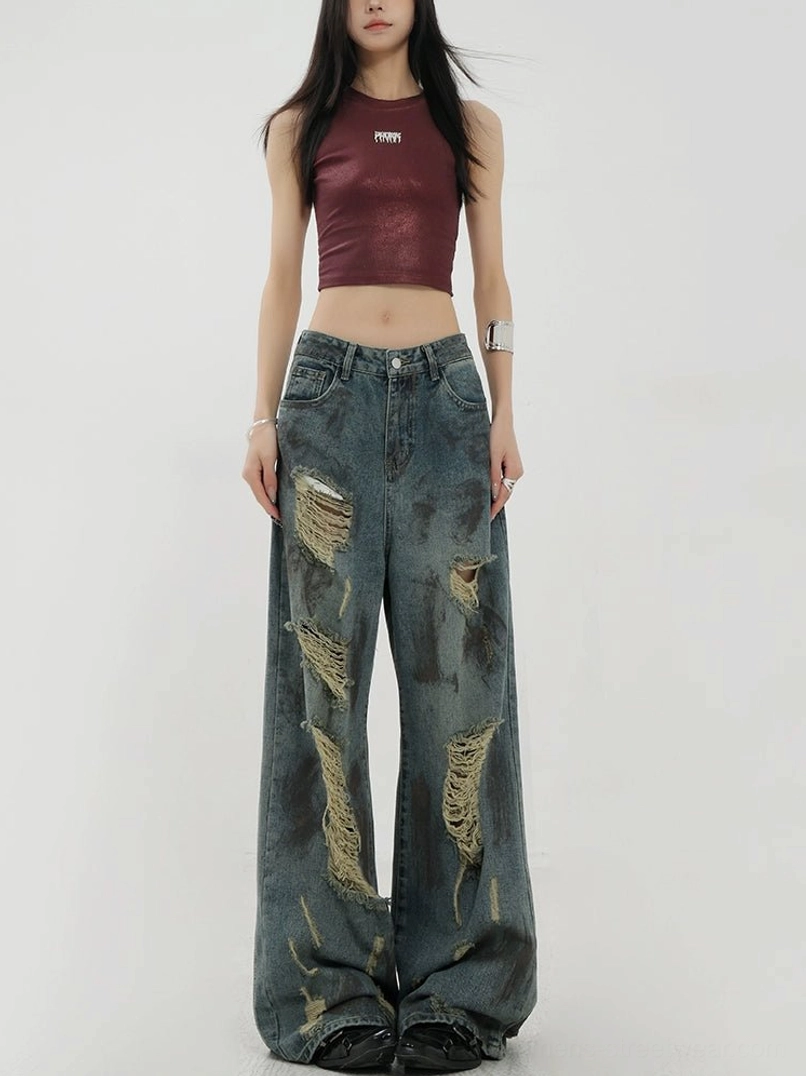 Front full-body view of women's retro blue tie-dye distressed wide-leg jeans with washed vintage denim and frayed ripped details