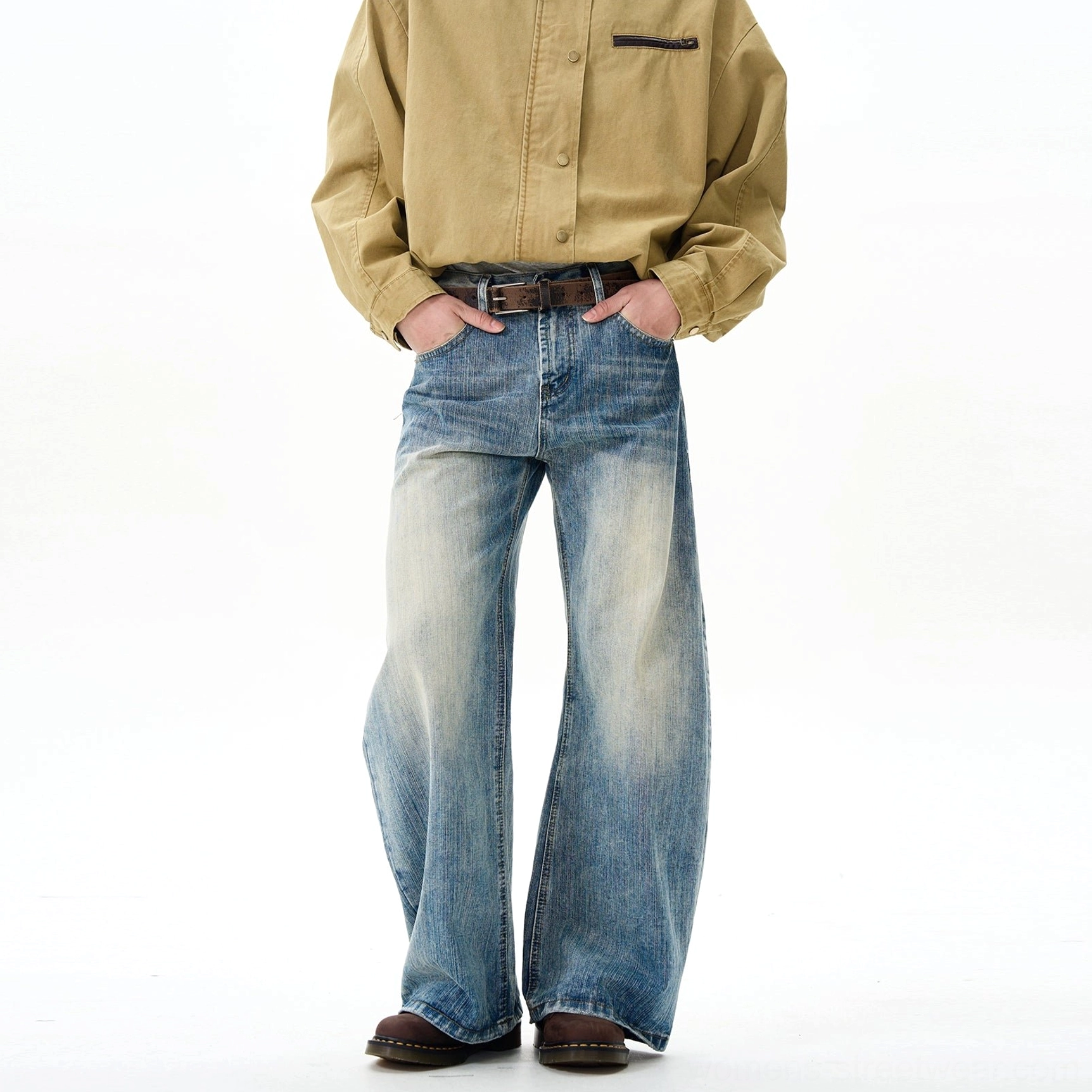 Three-quarter front view of retro unisex wide-leg denim jeans with relaxed fit, faded vintage blue wash, pocket styling, and casual streetwear outfit