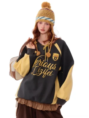 Grey and mustard retro varsity letter raglan sweatshirt with embroidered script logo and ruffle hem front view