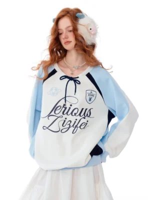 White and light blue retro varsity letter raglan sweatshirt with embroidered badge and ruffle hem front full body view