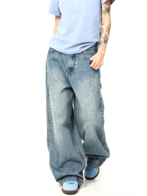 Side walking view of relaxed wide-leg vintage washed denim jeans showing natural fabric creases and streetwear volume