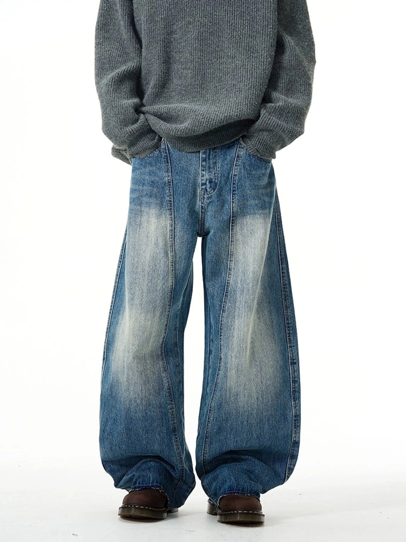 Front view of vintage faded blue wide-leg denim jeans styled with an oversized grey knit sweater for relaxed streetwear fashion