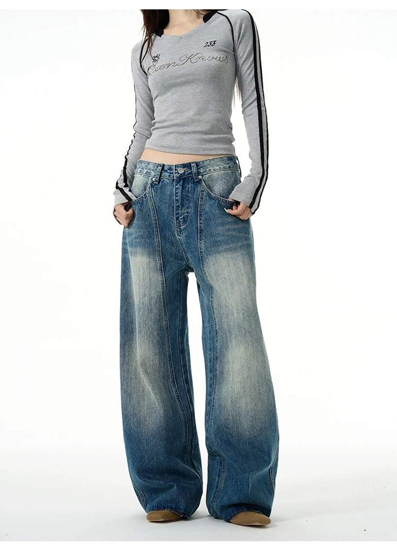 Front full-body view of vintage washed blue wide-leg jeans showing the waistband, front pockets, and relaxed oversized fit