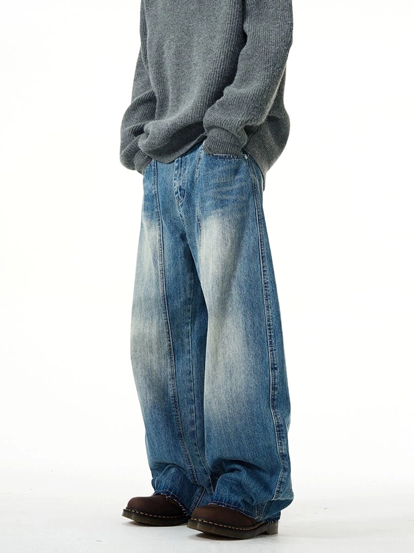 Right side view of relaxed oversized blue wide-leg jeans showing the loose silhouette, side pockets, and faded denim wash