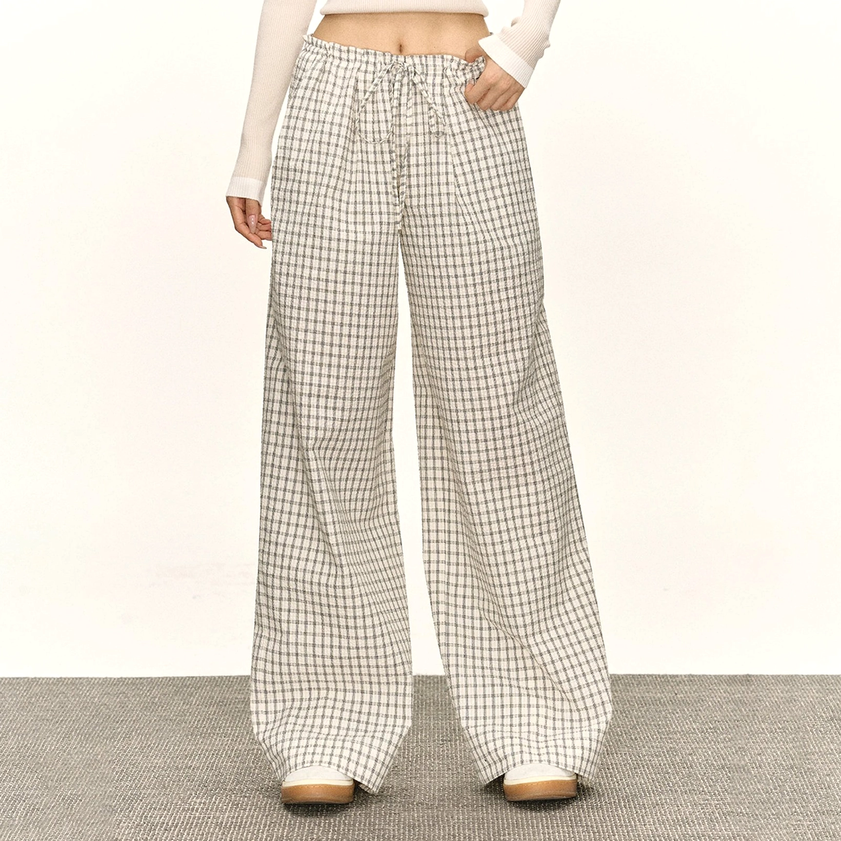 White retro plaid drawstring wide-leg streetwear lounge pants shown in a front full-length studio view