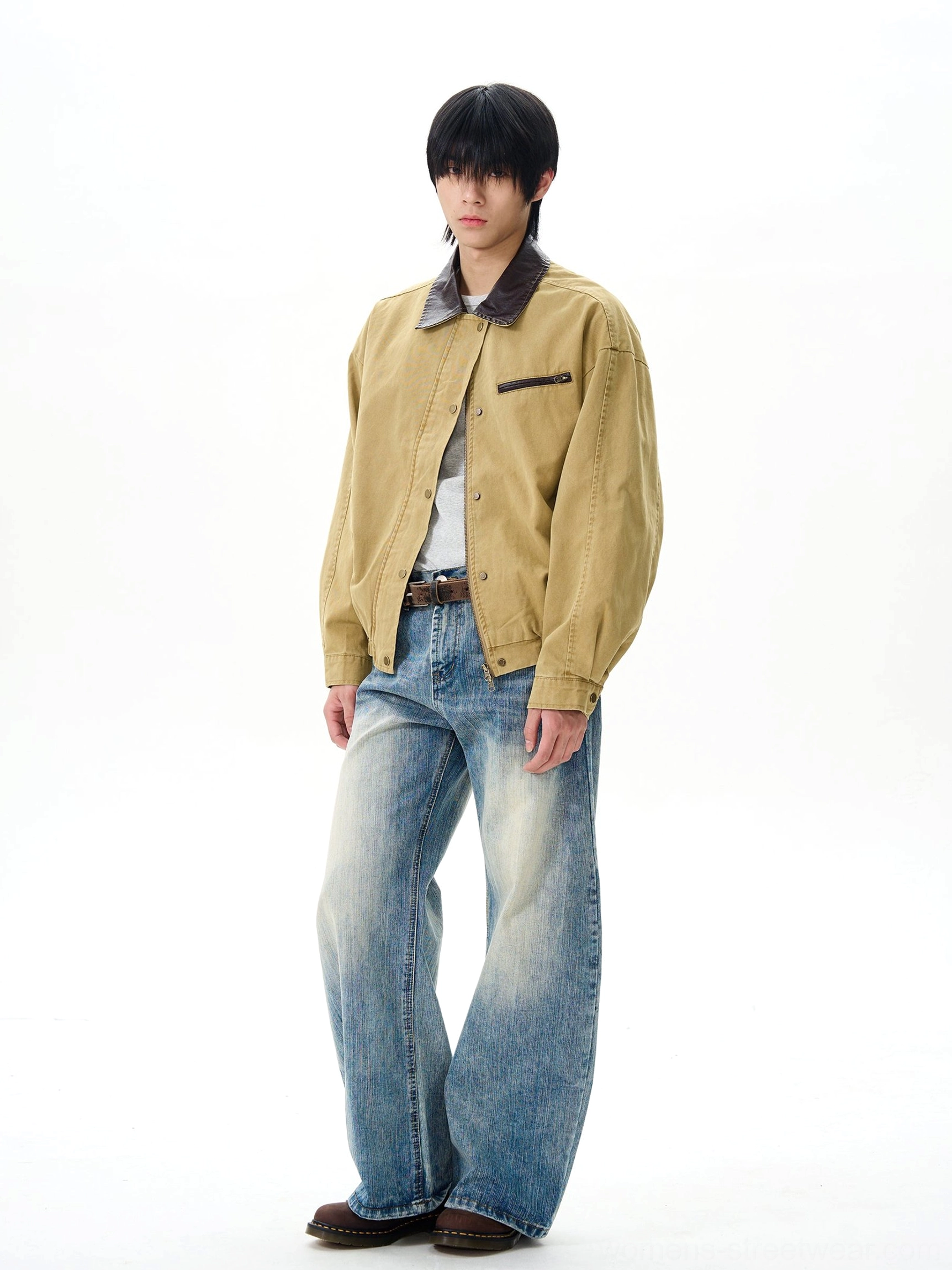 Full-body styling view of retro wide-leg denim jeans worn with a cropped yellow jacket, white shirt, brown leather belt, and dark loafers