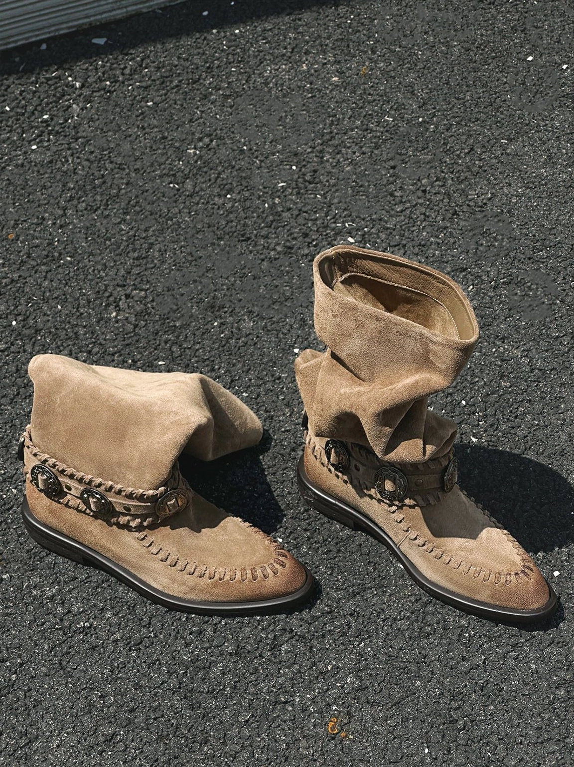 Retro women's western knee-high suede-textured riding boots in earthy brown tones with decorative buckles and relaxed shafts