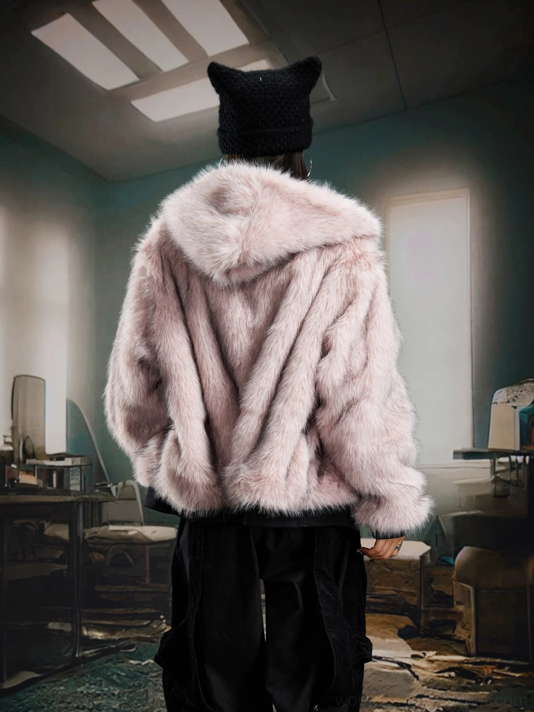 Reversible faux fur hooded bomber jacket detail showing plush texture, hood, zipper, and ribbed trim