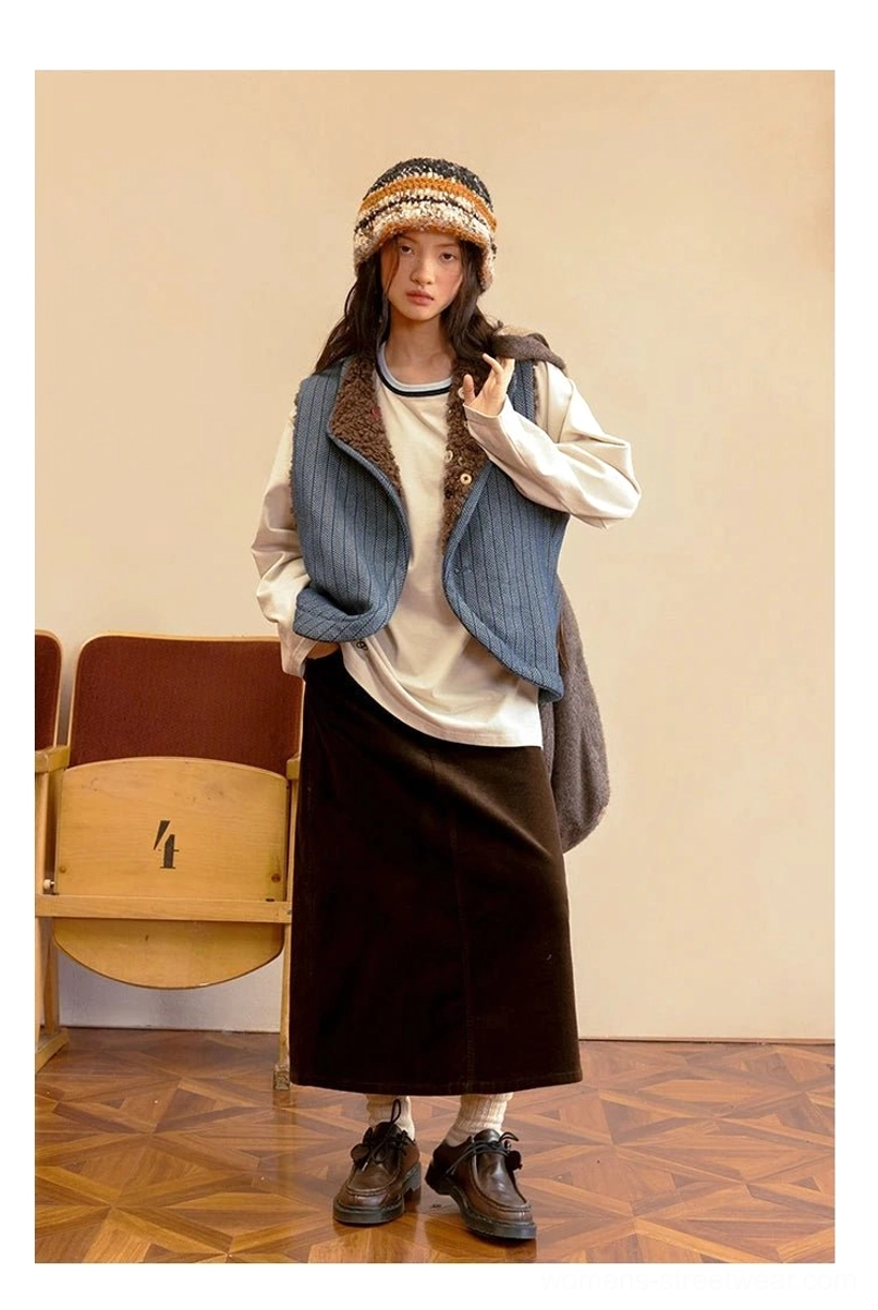 Blue ribbed denim side of reversible sherpa vest worn as a relaxed Korean streetwear layering piece