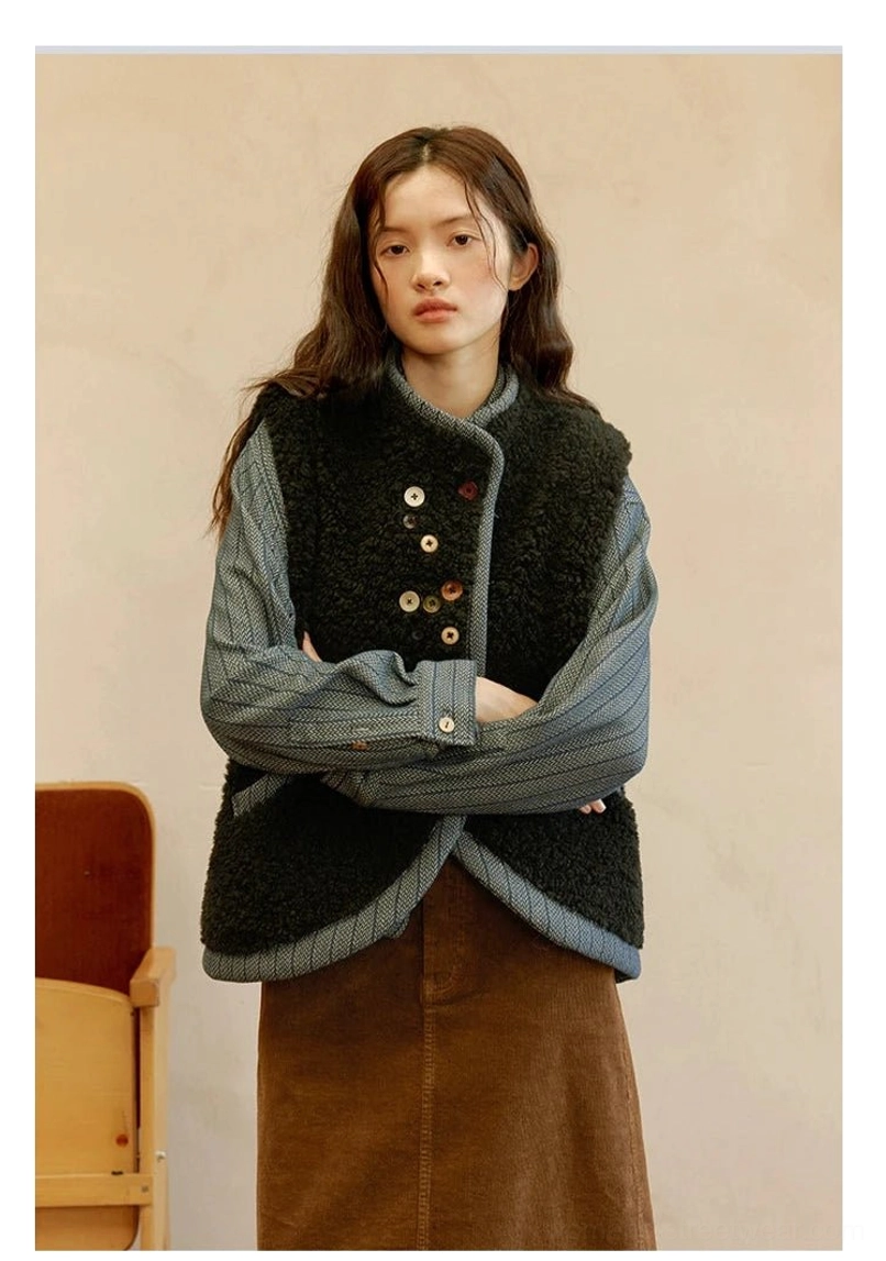 Reversible sherpa and denim vest detailed product view highlighting soft fleece texture, contrast edging, and button-front design