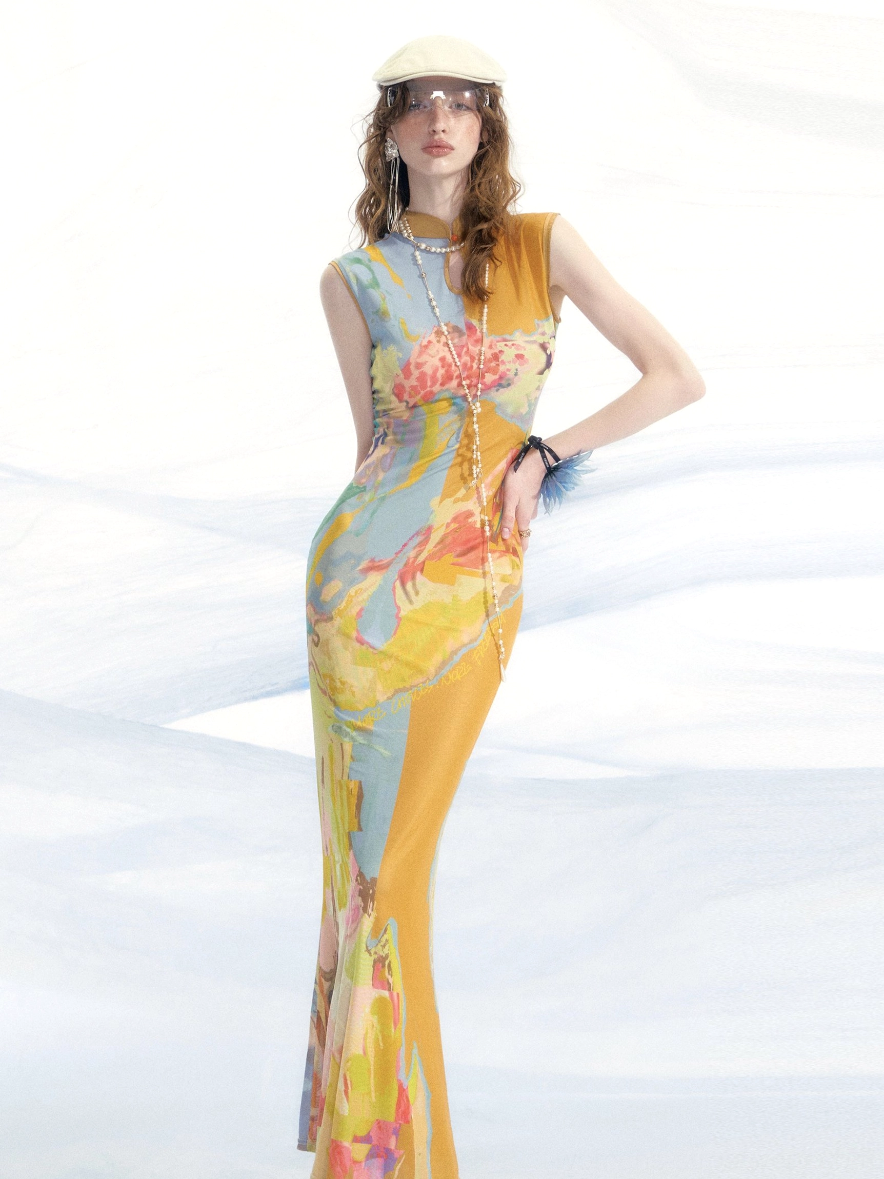 Front full body view of a sleeveless reversible watercolor print mesh cheongsam dress with mandarin collar and fitted fishtail hem