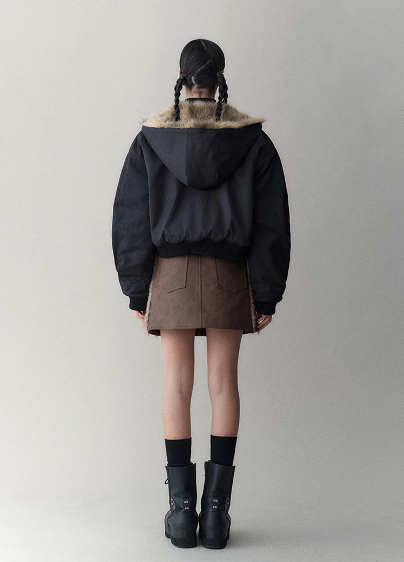 Winter streetwear jacket detail image featuring the reversible faux fur construction, cropped fit, and windproof black outer side