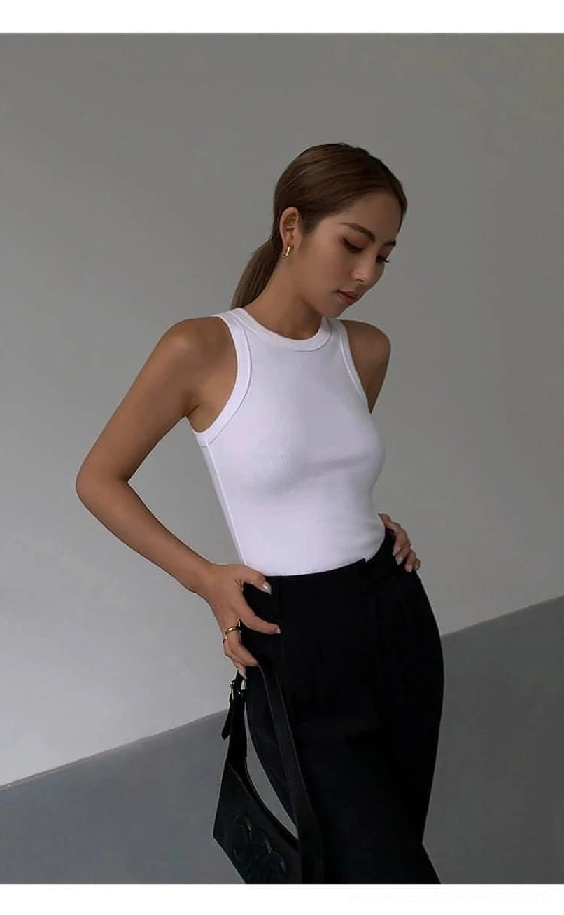 Ribbed knit tank top back view showing minimal construction and crew neck placement on model