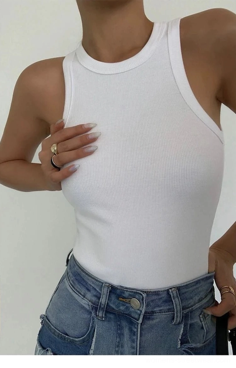 Ribbed knit tank top worn with leather accessories and structured handbag showing elevated casual aesthetic
